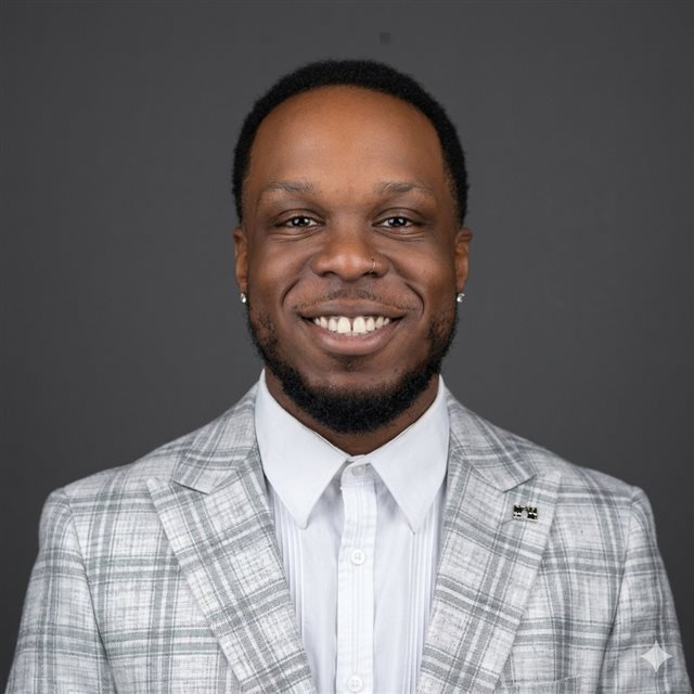 Devon, founder of Revuno, smiling in a light grey checked blazer